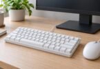 Generic compact wired keyboard with a mouse on a desk.
