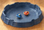Two toy spinning tops resting in a play arena on the floor.