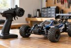 Generic pistol-grip RC radio transmitter beside a radio-controlled car.