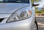 Generic clear front headlamp on an unbranded silver compact car.
