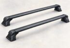 Two unbranded black roof-rack crossbars with mounting feet, shown detached on a neutral surface.