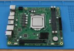 Generic unbranded compact motherboard on a work mat.