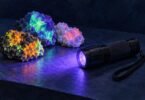 Illustration of a generic UV inspection flashlight and fluorescent mineral specimens.