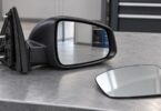 Generic unbranded vehicle side-mirror assembly and a separate mirror-glass piece.