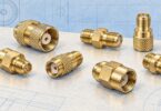 Generic small threaded coaxial fittings shown separately on a pale work surface.