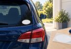 Generic blank oval decal near the lower corner of a parked car window.