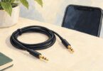 Illustration of a coiled stereo audio cable beside the upper part of a smartphone.