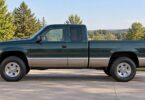 Generic older pickup truck parked on a level driveway, shown in side profile.