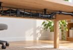 Generic under-desk cable tray and reusable cable ties holding cords neatly.
