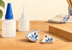 Unbranded instant adhesive bottles beside ceramic fragments and a wood offcut.