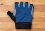 Generic blue fingerless cycling glove shown from above on a wooden surface.