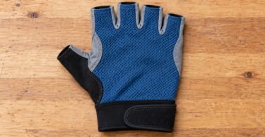 Generic blue fingerless cycling glove shown from above on a wooden surface.