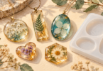 Illustration of finished resin pendants and floral trinkets beside an empty silicone mold.