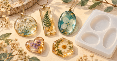Illustration of finished resin pendants and floral trinkets beside an empty silicone mold.