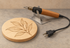 Illustration of an unplugged wood-burning pen in a metal stand beside a wooden plaque with a leaf pattern.