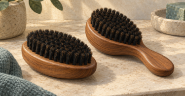 Illustration of two unbranded wooden hair brushes with dark bristles on a neutral surface.