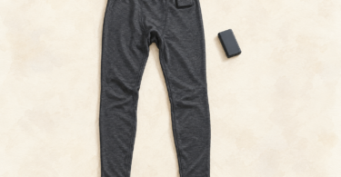 Illustration of plain base-layer pants laid flat beside a separate disconnected battery pack.
