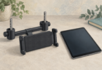 Illustration of a generic tablet holder with headrest-post clamps beside a blank-screen tablet.
