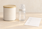 Illustration of a closed unbranded container, an empty capped feeding bottle and a blank checklist on a clean surface.