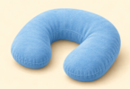 AI-generated editorial illustration of a small blue U-shaped travel pillow on a cream background.