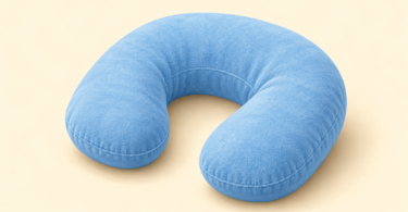 AI-generated editorial illustration of a small blue U-shaped travel pillow on a cream background.