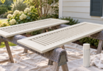 AI-generated illustration of light ivory louvered vinyl shutters on padded sawhorses beside a plain aerosol paint can.