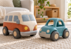 A generic fabric toy van and a teal plastic toy car on a pale rug in a bright living room.