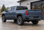 Illustration of an unbranded blue pickup parked on level concrete outside an automotive workshop.