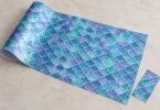 Illustration of an unbranded craft sheet with an original teal, blue, and violet mermaid-scale pattern.