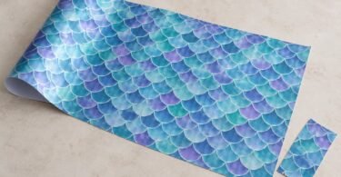 Illustration of an unbranded craft sheet with an original teal, blue, and violet mermaid-scale pattern.