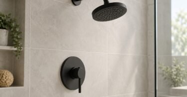 Illustrative unbranded matte-black showerhead and lever trim on a pale tiled wall