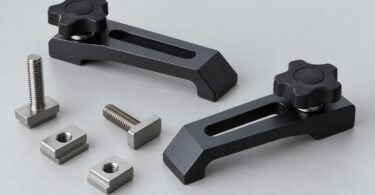 Two generic hold-down clamps with star knobs, T-bolts and T-nuts on a gray surface.