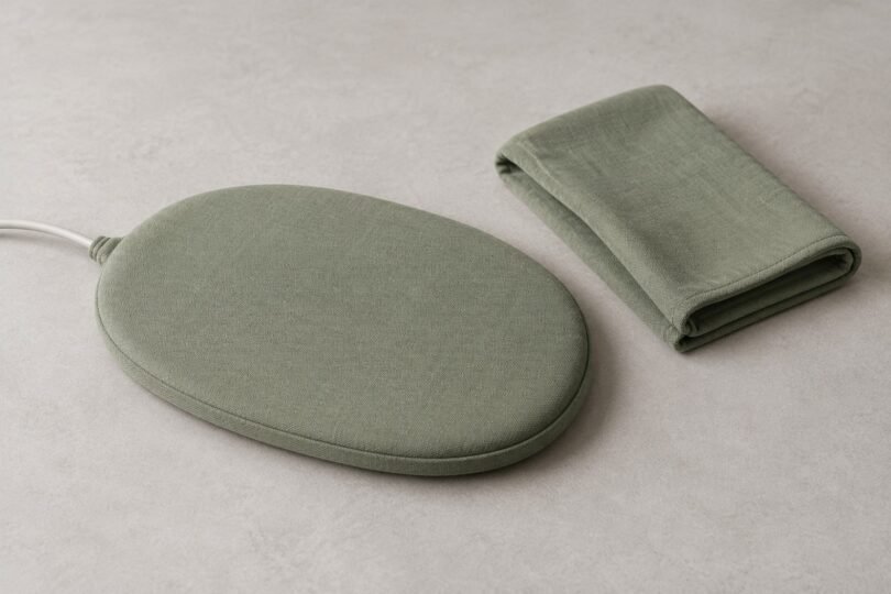Generic fabric-covered pet warming pad with a folded cover on a tabletop
