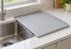 Illustration of an unbranded ribbed dish drain board beside a kitchen sink.