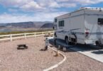 Motorhome parked on a campsite pad overlooking Lake Mead and desert mountains