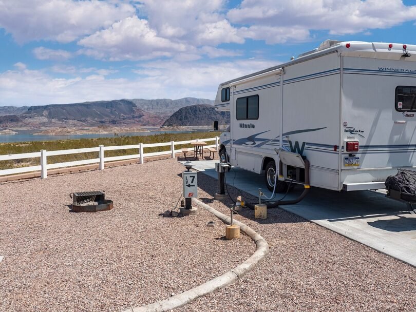 Motorhome parked on a campsite pad overlooking Lake Mead and desert mountains