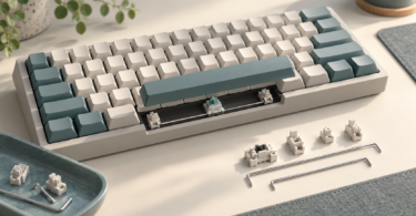 Illustration of an unbranded mechanical keyboard with a lifted spacebar and stabilizer parts on a workbench