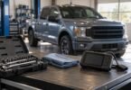Illustration of socket tools and a diagnostic scanner on a workshop bench with an unbranded pickup in the background.