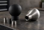 Illustration of generic manual shift knobs and adapter collars on a workshop bench