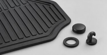 Illustration of a black rubber floor mat beside a loose cap, ring and hook-shaped retaining piece