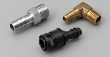 Three detached unbranded metal and plastic vacuum fittings on a gray surface
