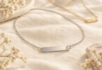 Illustration of blank silver-tone and gold-tone necklace pendants with clear crystal accents on ivory linen.