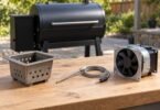 Generic pellet grill parts, including a burn pot, unplugged probe, and fan, arranged on an outdoor workbench.