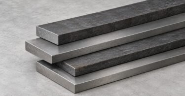 Illustration of plain rectangular steel bars stacked on a gray surface.