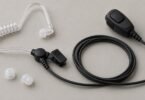 Illustration of a generic acoustic-tube earpiece, lapel microphone, cable, and spare tips.