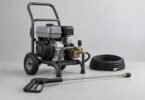 Unbranded wheeled gas pressure washer with a coiled hose and spray wand on a neutral studio floor