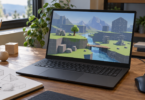 An unbranded laptop showing a fictional low-poly landscape beside a mouse and a sketchbook.