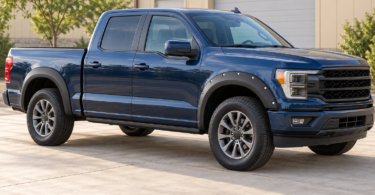 Illustration of an unbranded blue crew-cab pickup with black front and rear fender flares, parked outside a workshop.