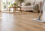 Microfiber mop and plain white bottle beside a light wood-look floor in a living room