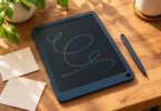 Illustration of a generic LCD writing slate with green loops and a stylus on a wooden desk